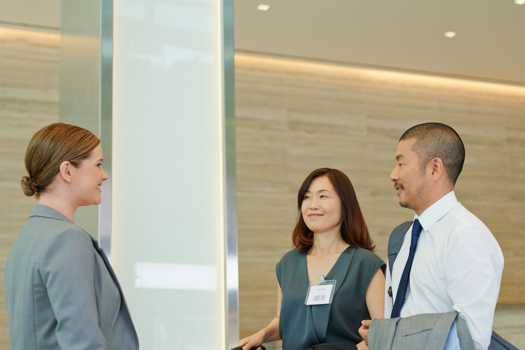 Business man and business woman meeting a concierge. Group of business people meeting their concier