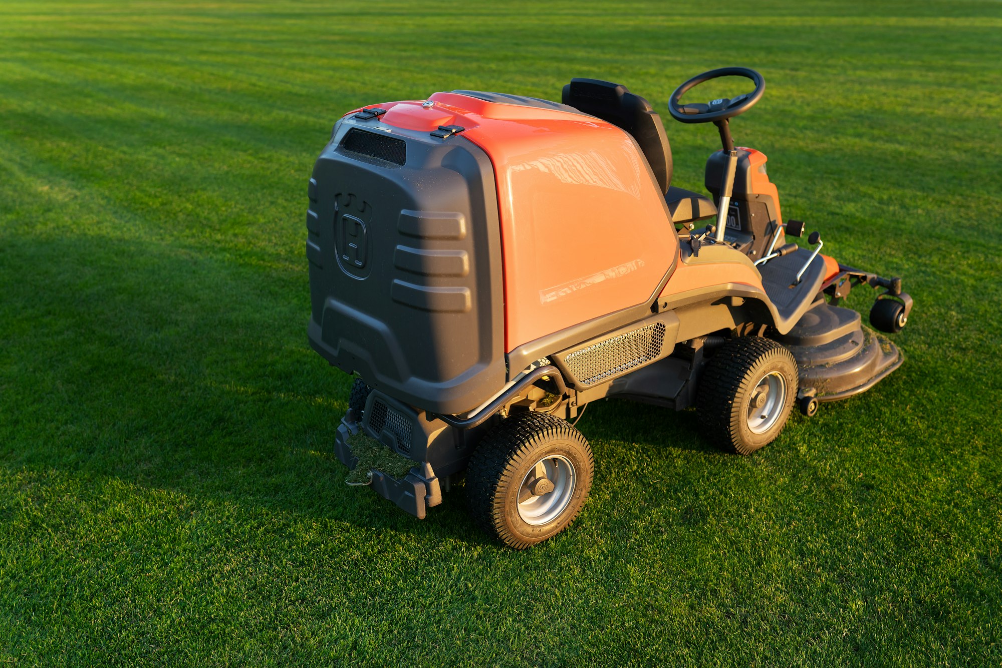Dubno, Ukraine-September 22, 2021: Autumn maintenance of the football field. Lawn mower on the field